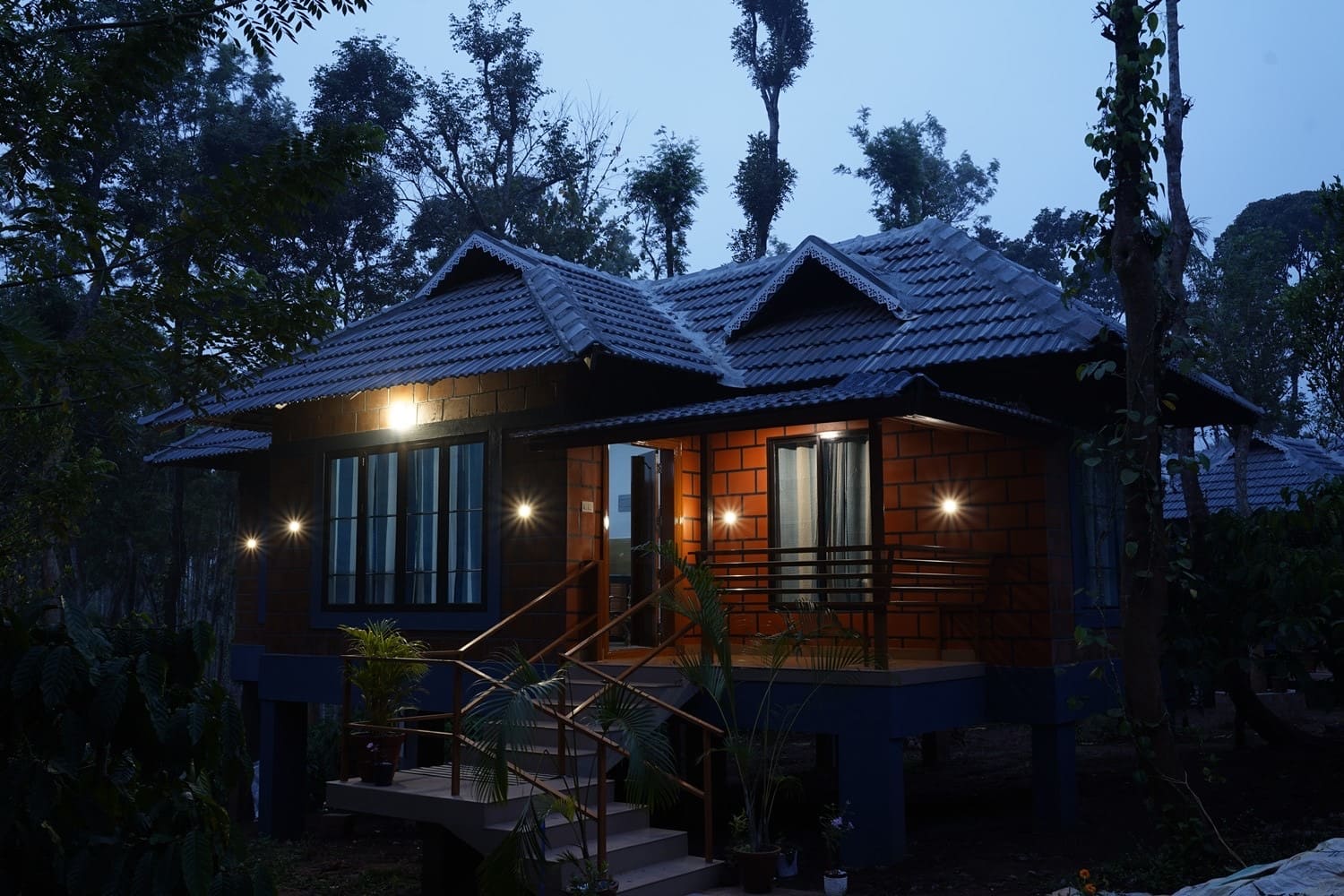 Warm lights outside a Coffeepolo villa at dusk
